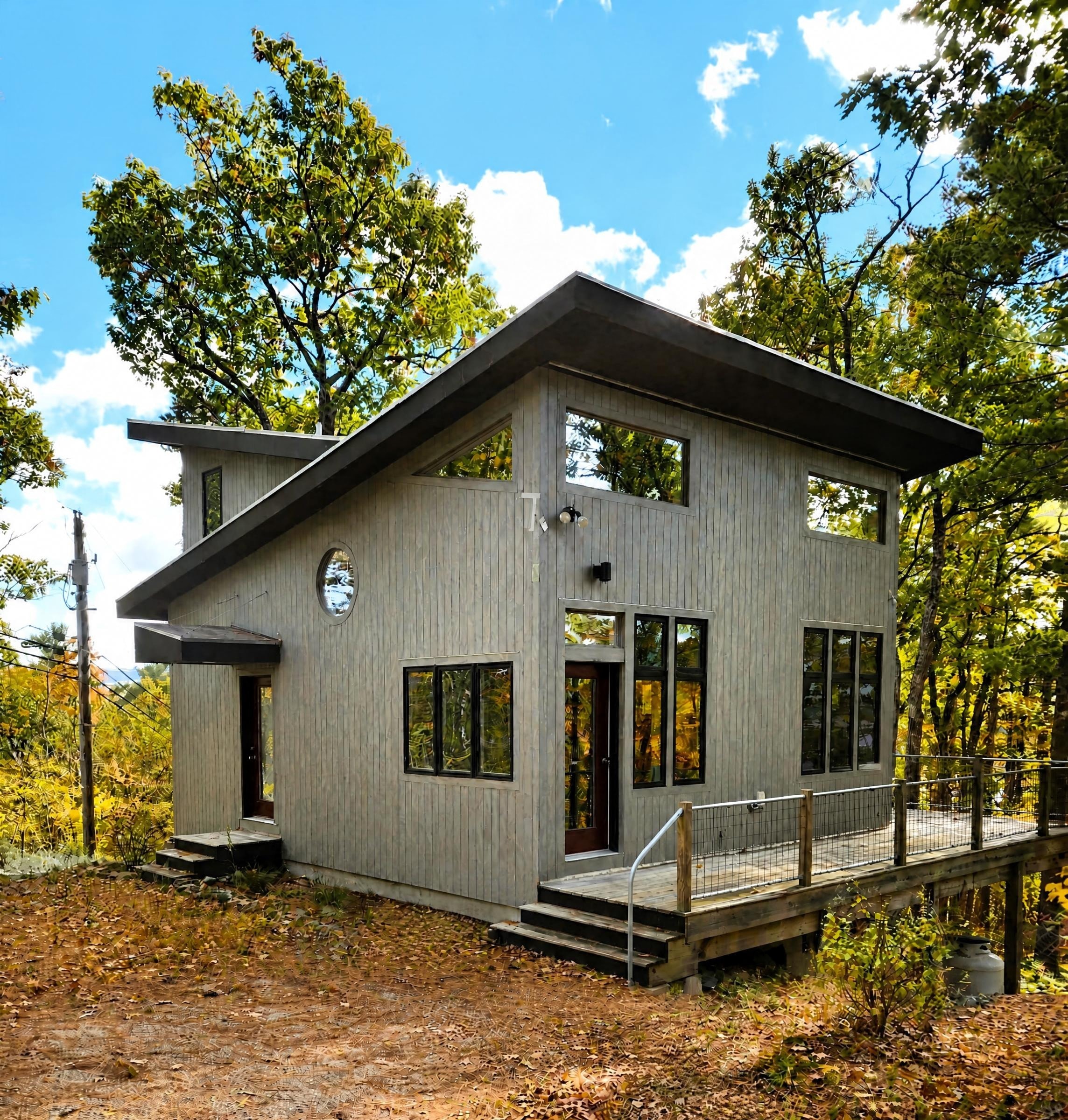 Front exterior — taupe vertical siding with deck