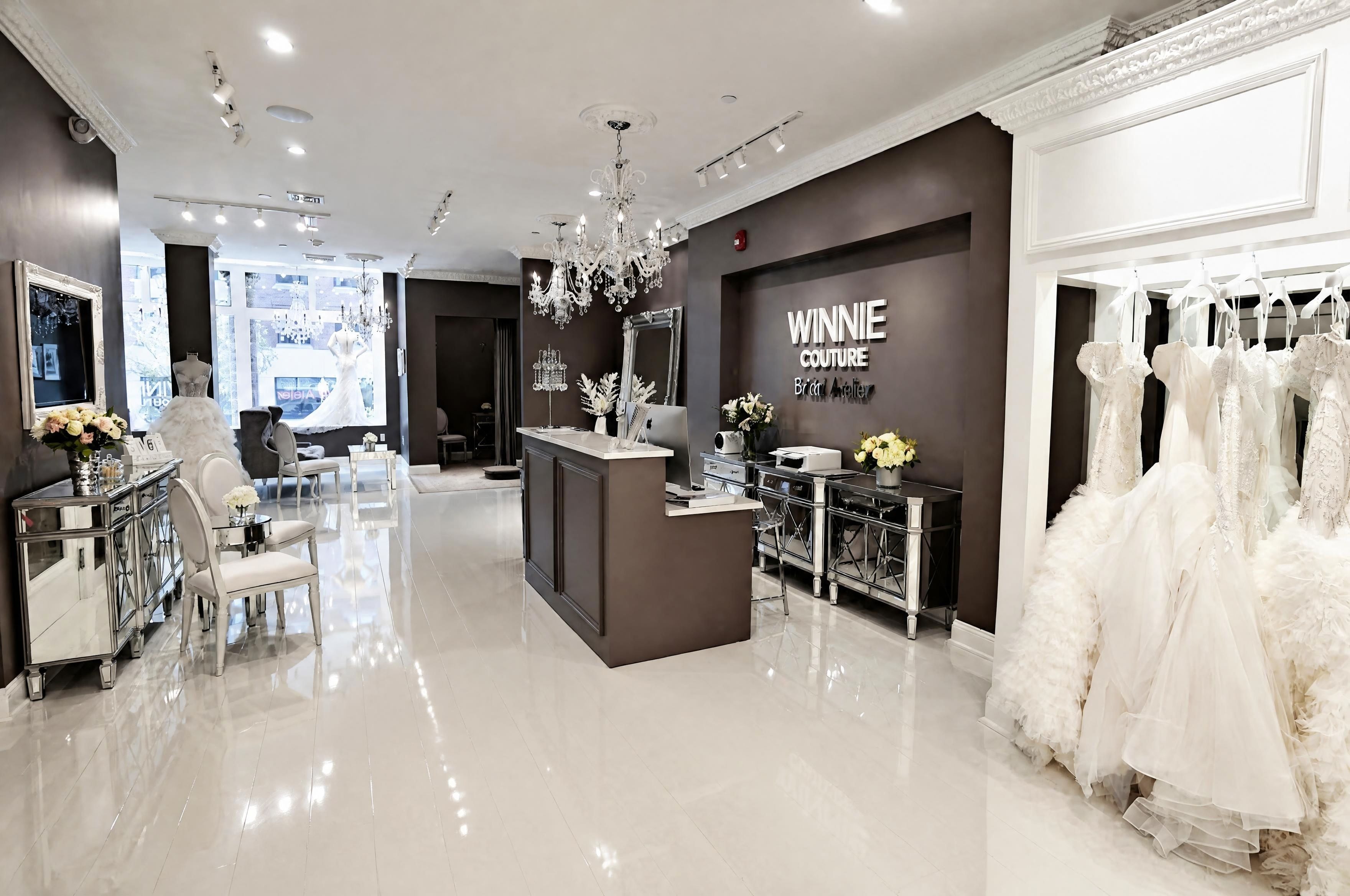 Reception area with crystal chandeliers and bridal gown displays
